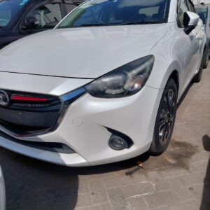 A white Mazda Demio parked at Mombasa Car Deals Ltd. Cars for sale in Mombasa.